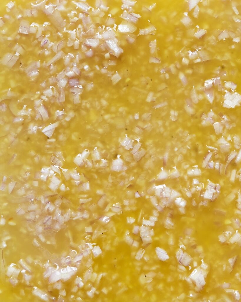 Yellow dressing with chopped shallots