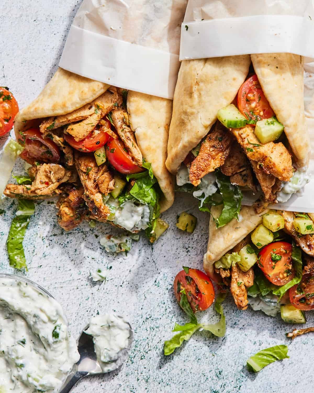 Chicken Gyros wrapped in parchment paper with extra tzatziki