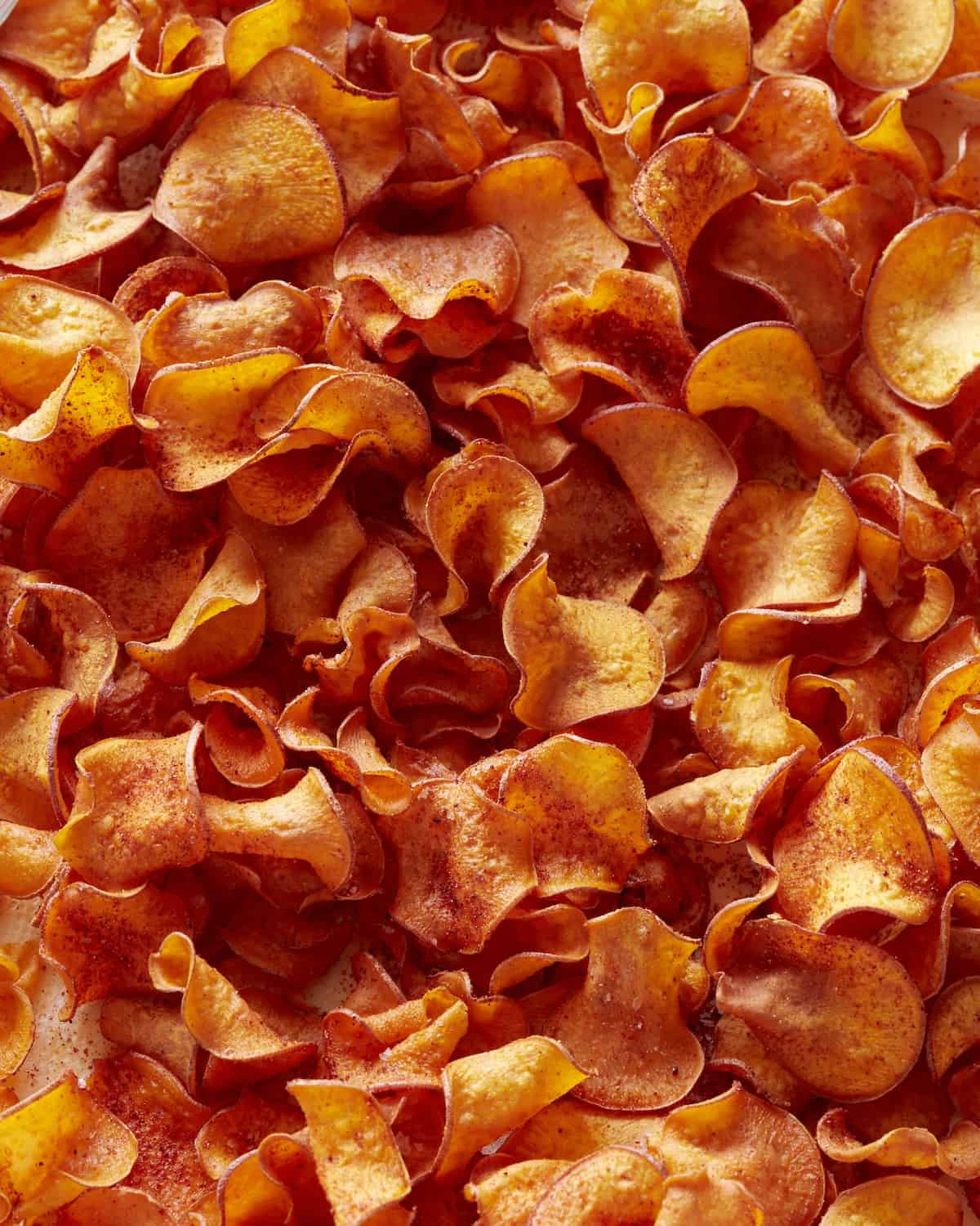 An overhead close-up shot of spicy BBQ sweet potato chips.