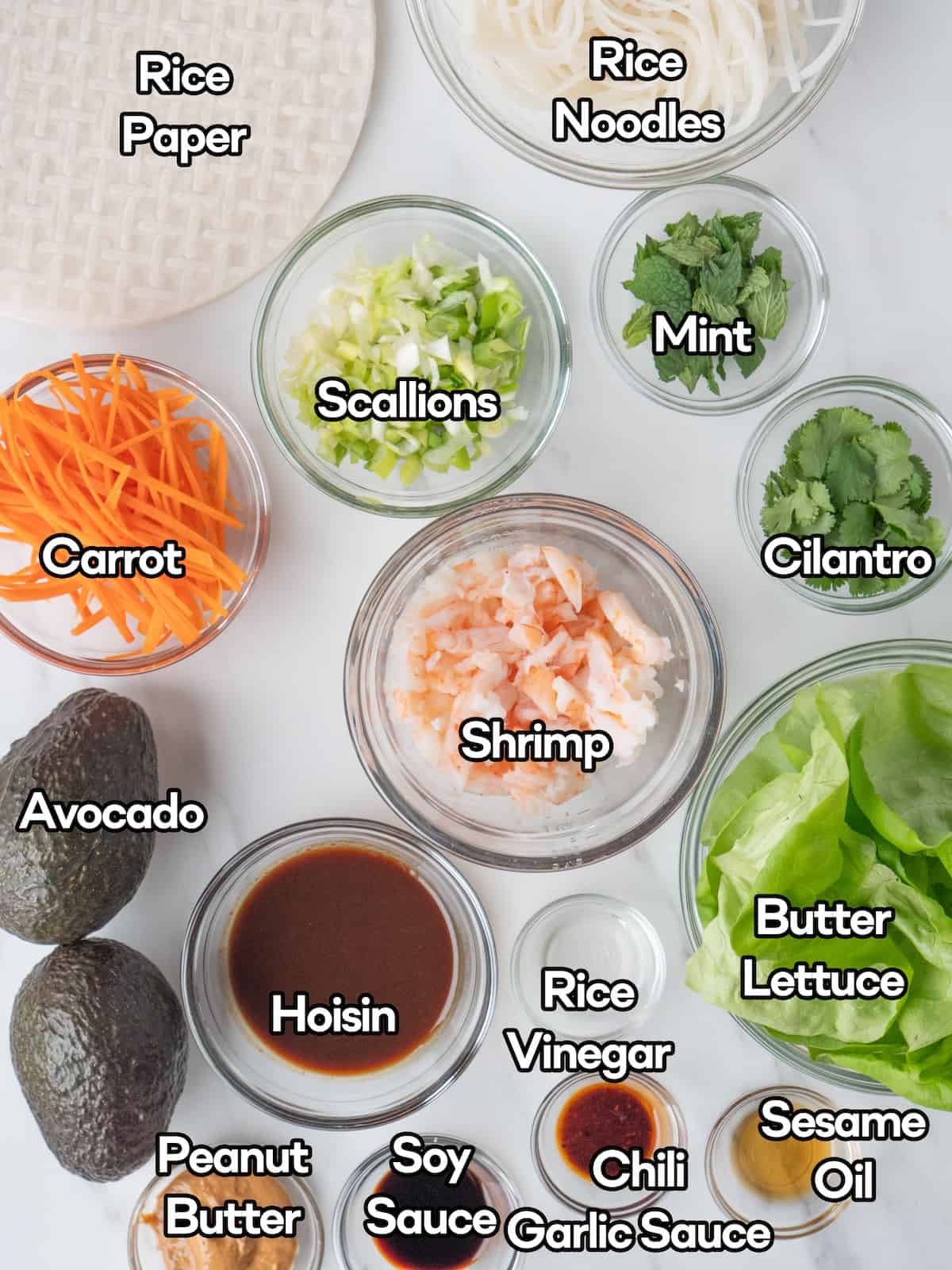 Mise en place of all ingredients to make avocado shrimp spring rolls.