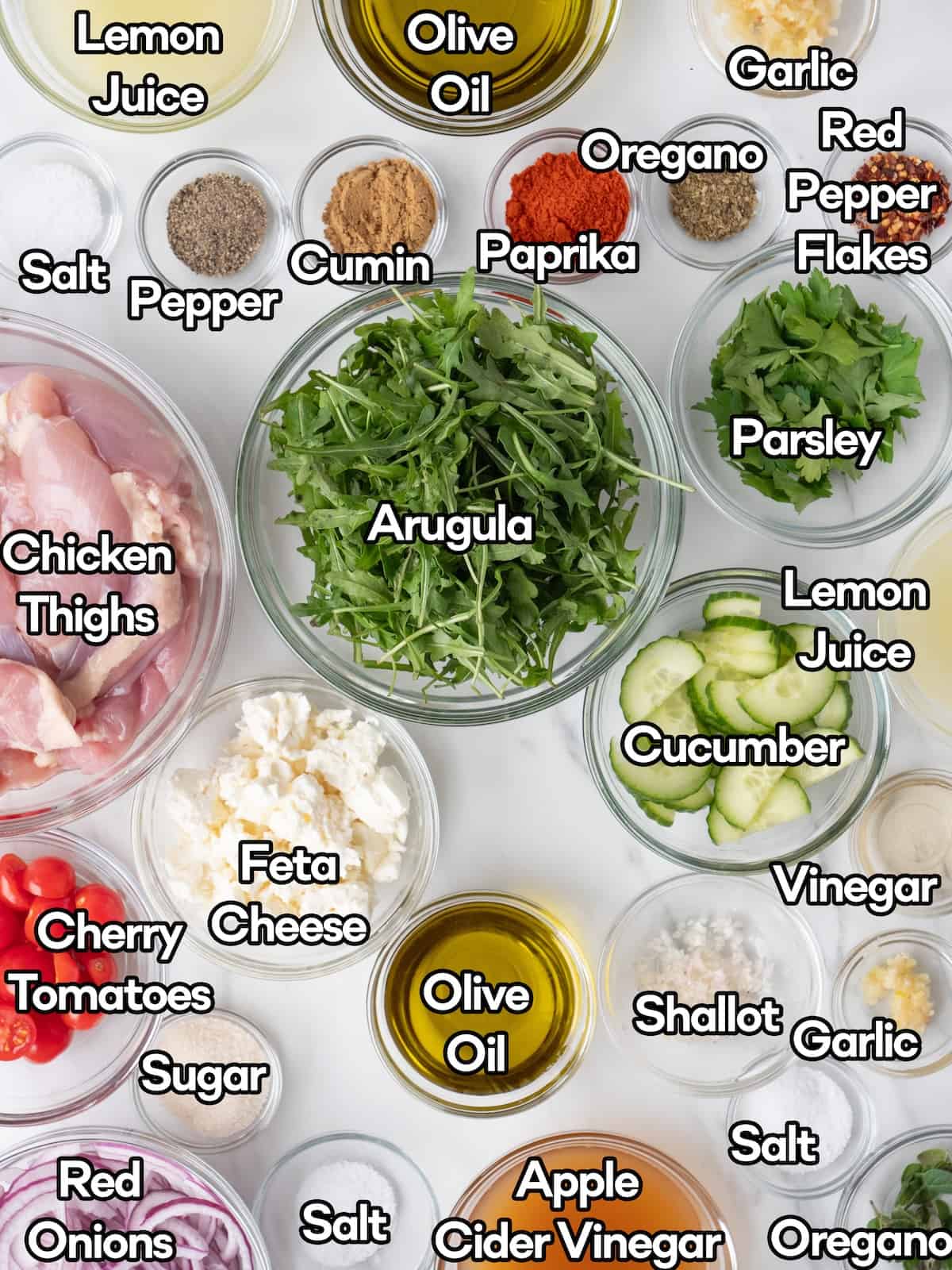 Mise en place of all ingredients to make greek chicken salad.