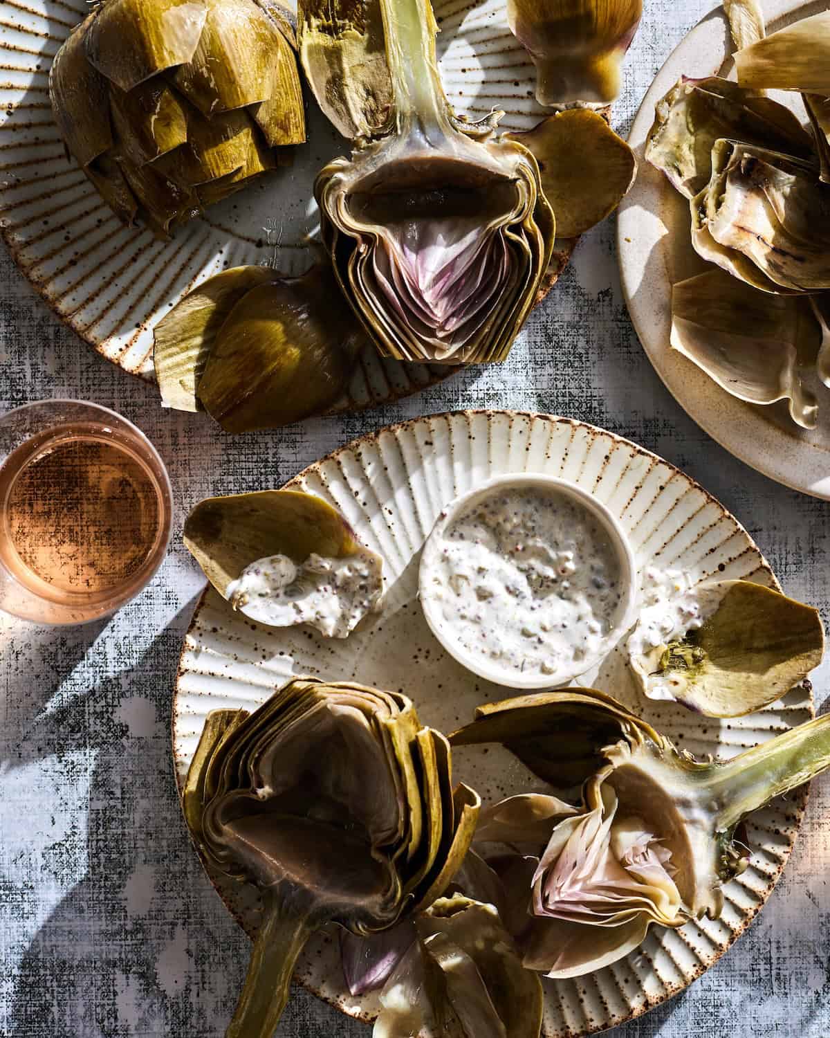 An assortment of Steamed Artichokes with a Caper Dipping Sauce