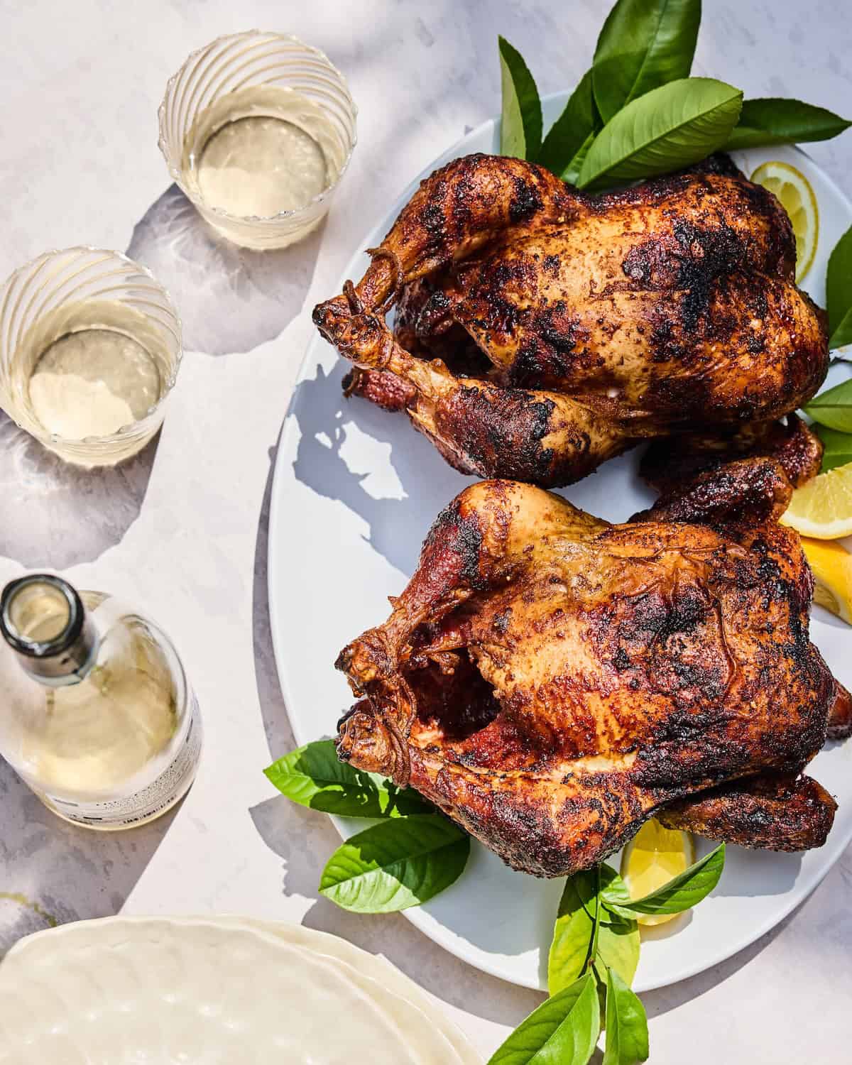 The Perfect Rotisserie Chicken with wine glasses 
