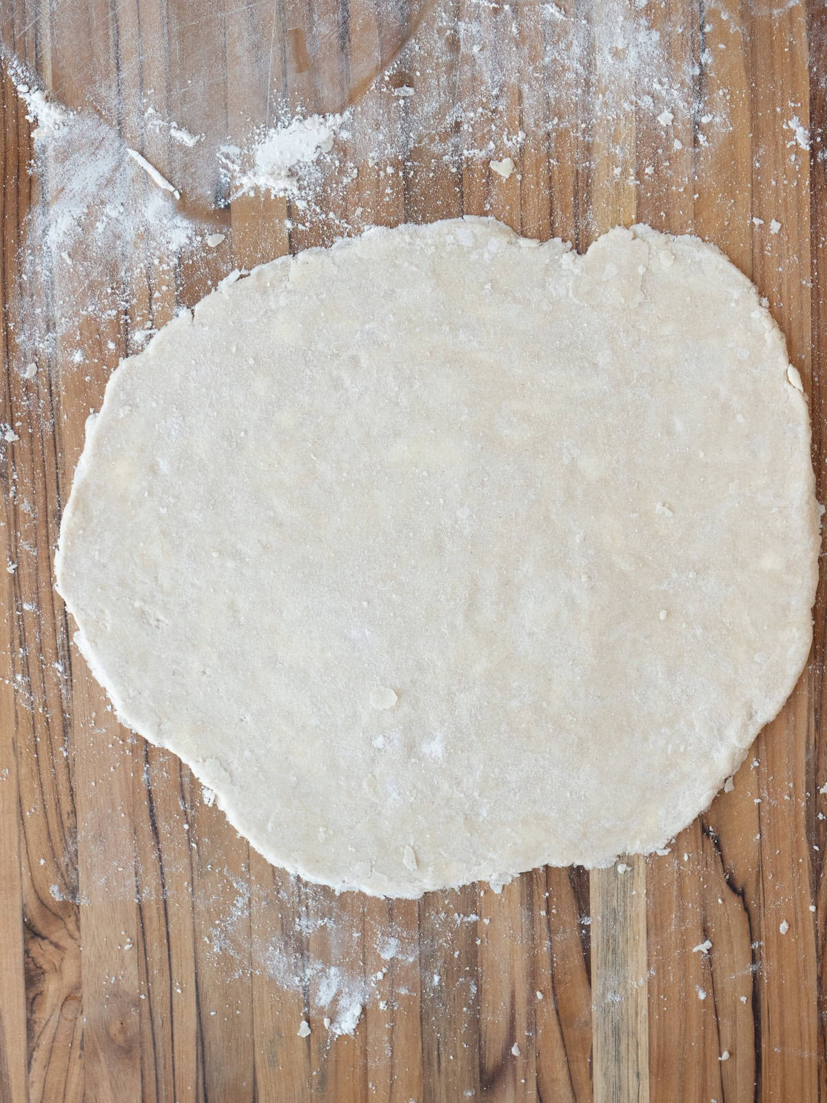 Pie dough rolled out into a large circle.