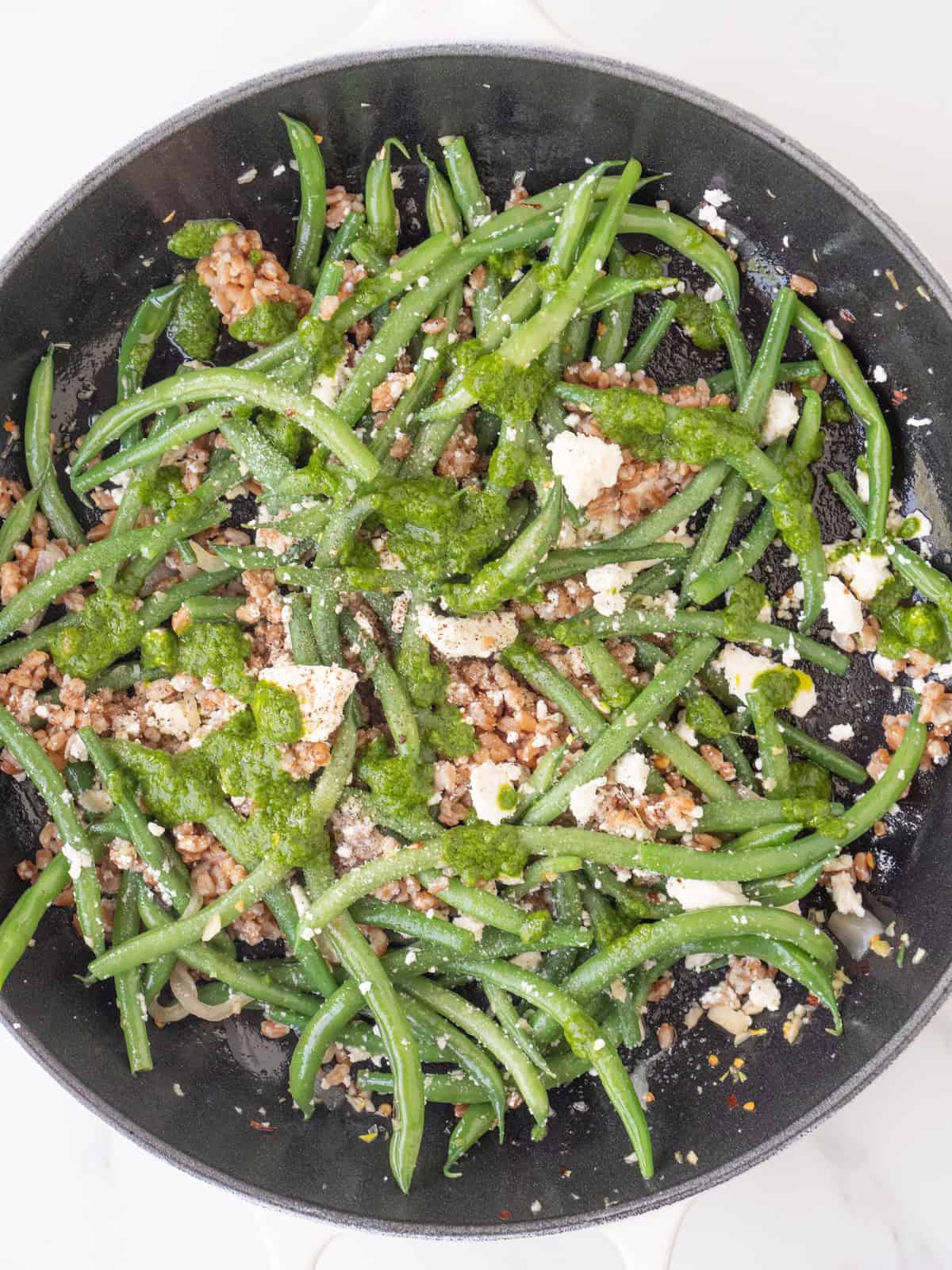 A skillet with green bean farro salad.