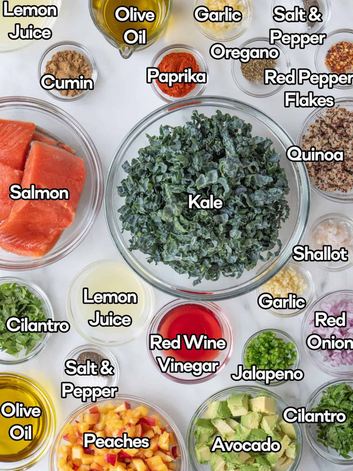 Mise en place of all ingredients to make a summer salmon salad with stone fruit, strawberries and avocado.