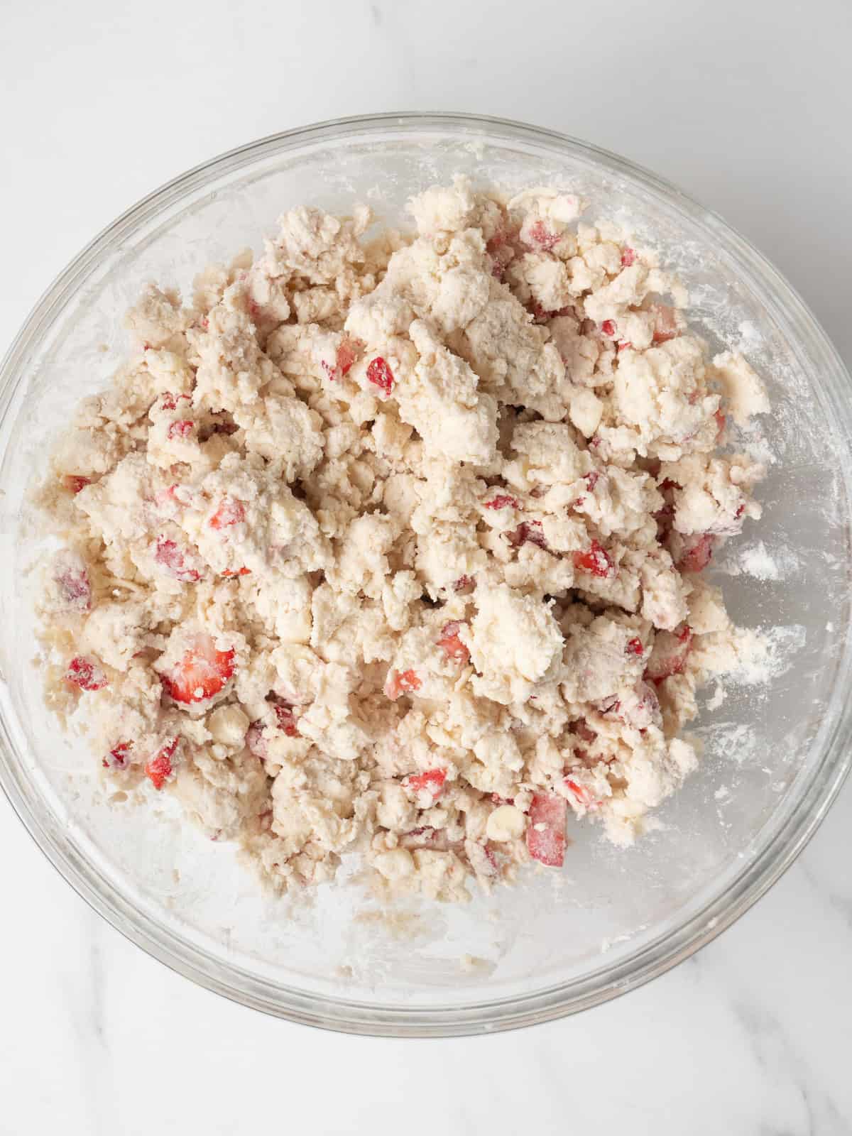 A large mixing bowl with the dough ready to make strawberry white chocolate scones.