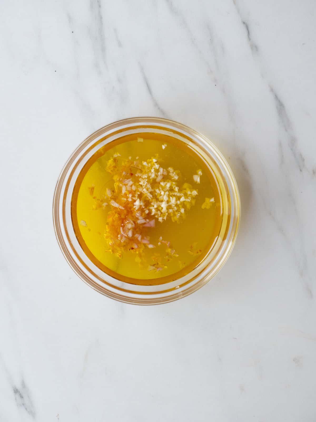 A small bowl with all the ingredients to make Lemon-Champagne vinaigrette.