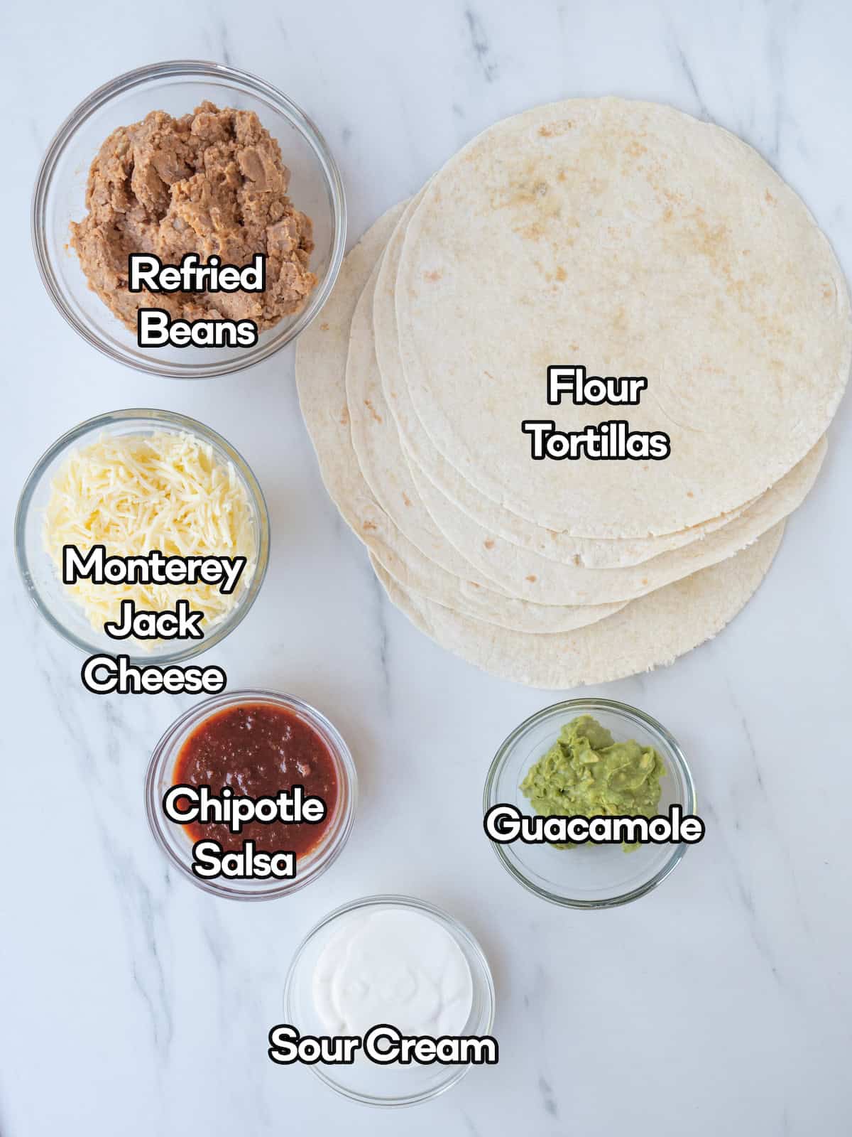 Mise en place of all ingredients to make bean and cheese burritos.