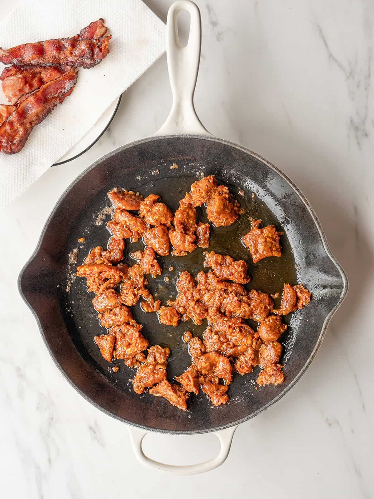 Cooked chorizo sausage in skillet with bacon