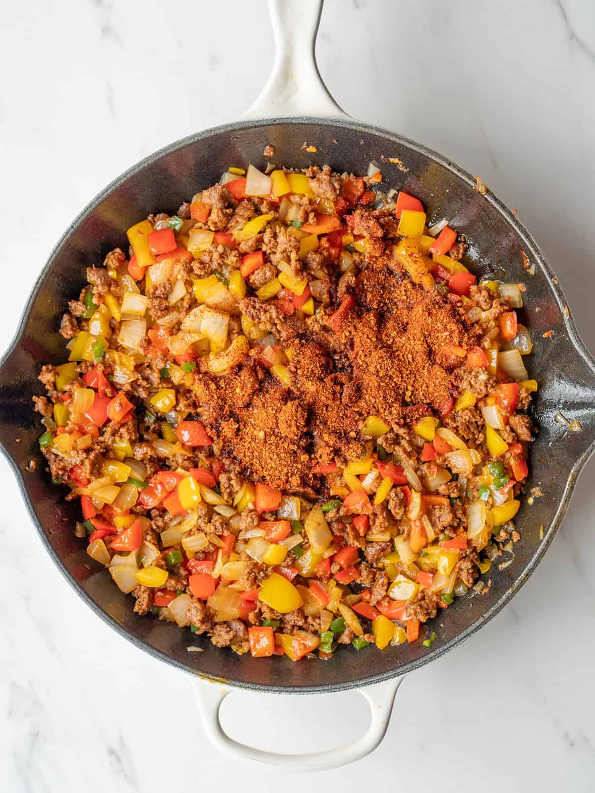 Colorful vegetables and spices in skillet