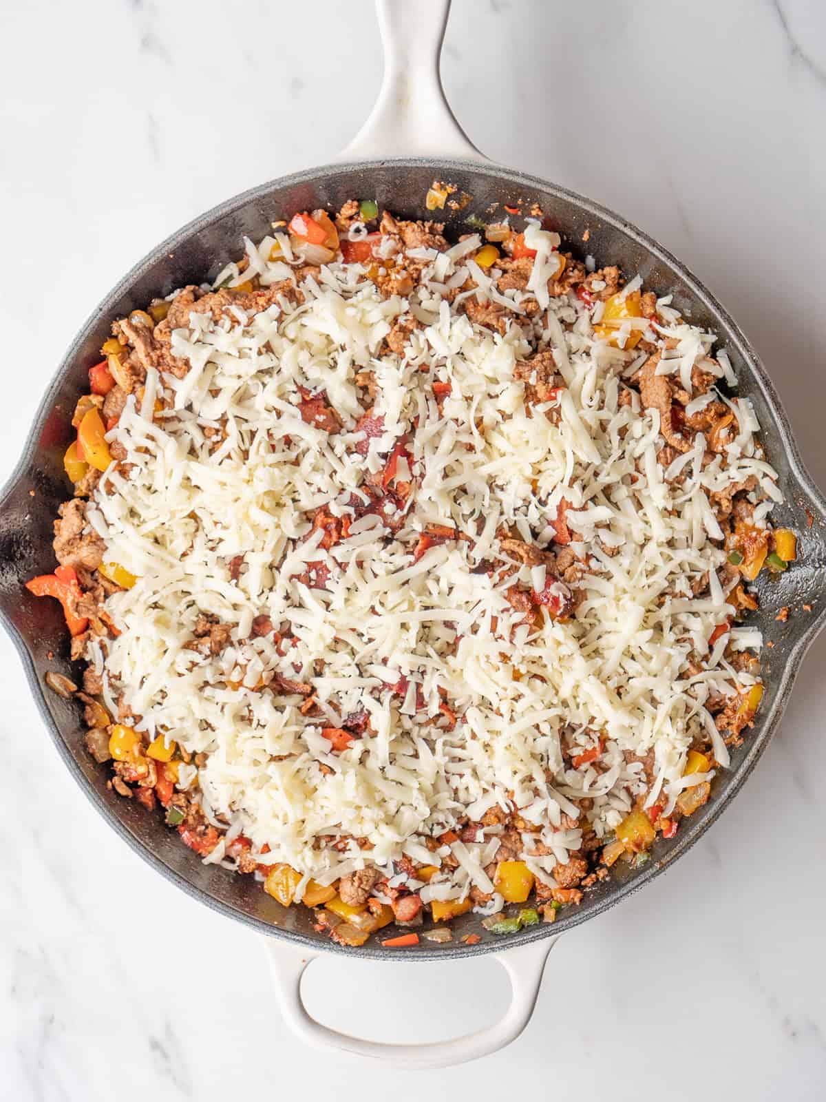 Skillet with meat and cheese topping