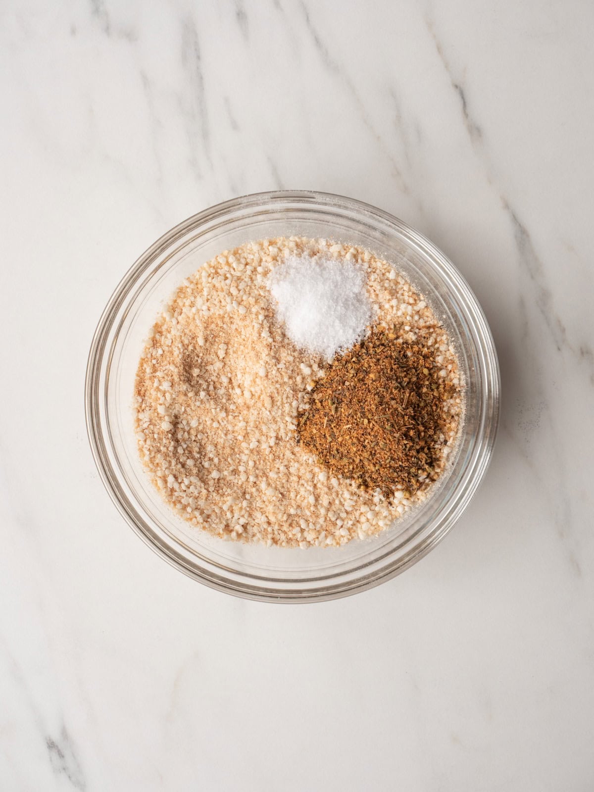 A small mixing bowl with toasted panko breadcrumbs, salt and Gaby's Everyday Dalkin & Co seasoning.