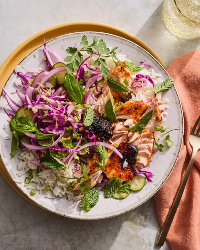 Salmon, rice, vegetables, fresh herbs.