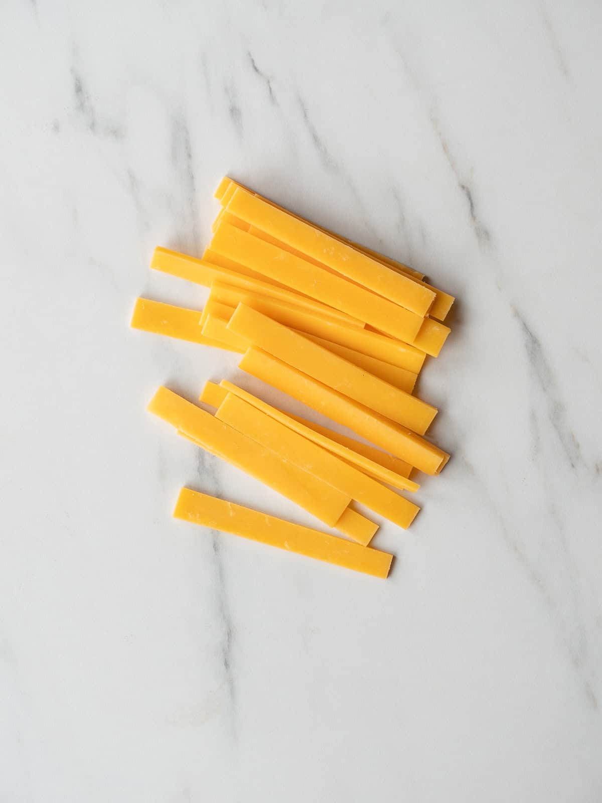 Thin strips of sharp cheddar cheese
