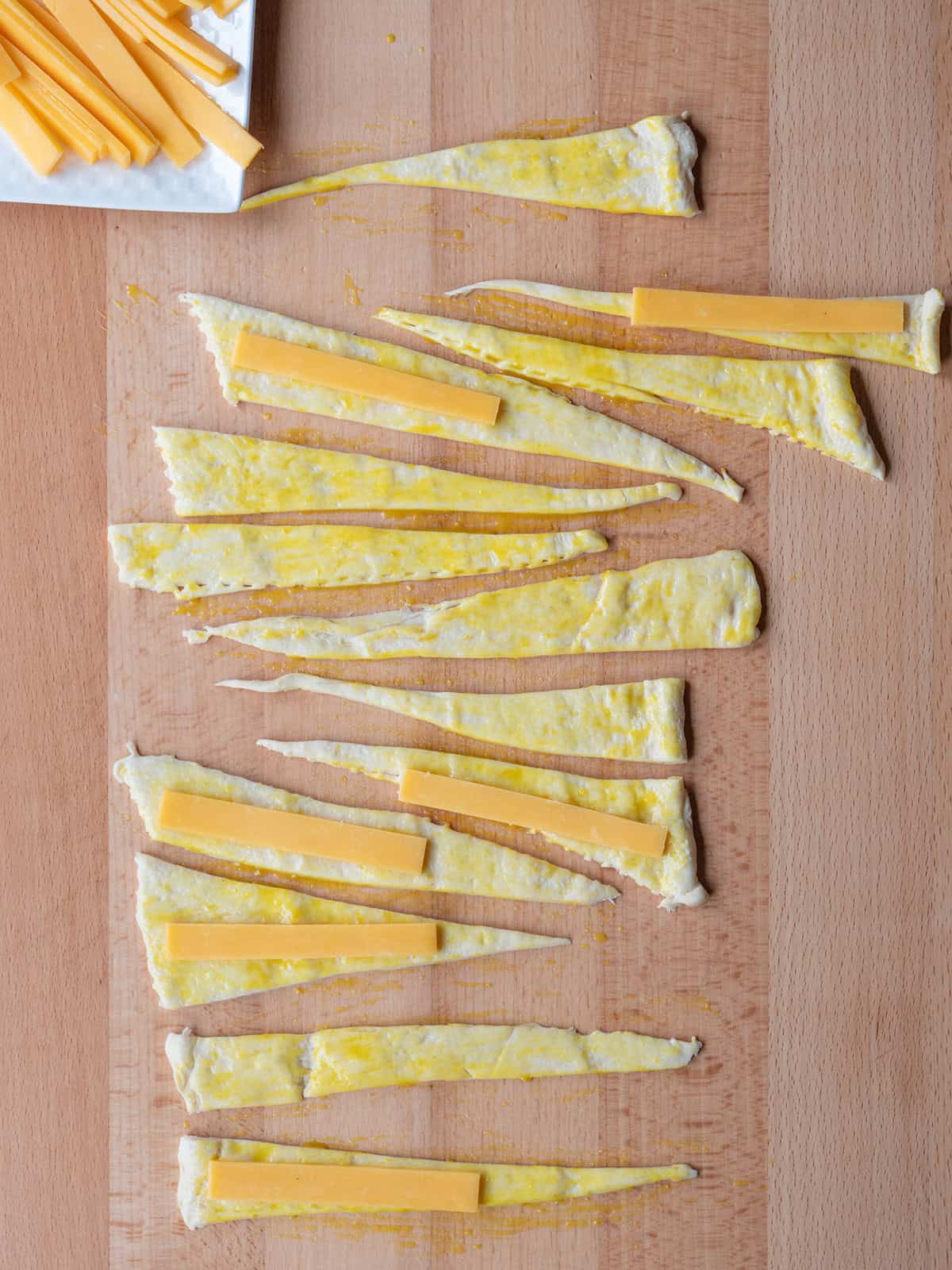 Crescent roll dough with honey mustard and cheddar cheese strips