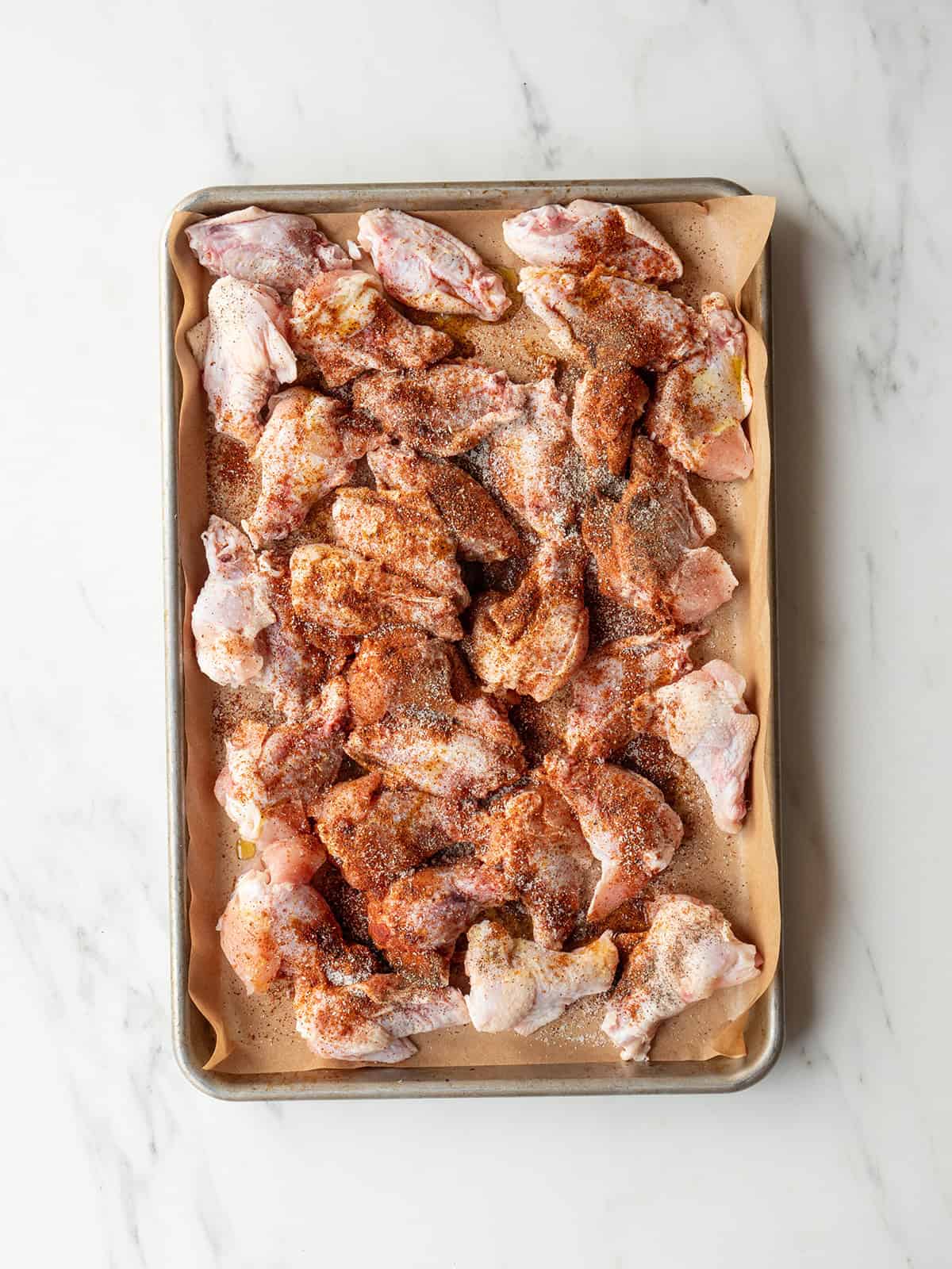 Raw chicken wings seasoned with spices