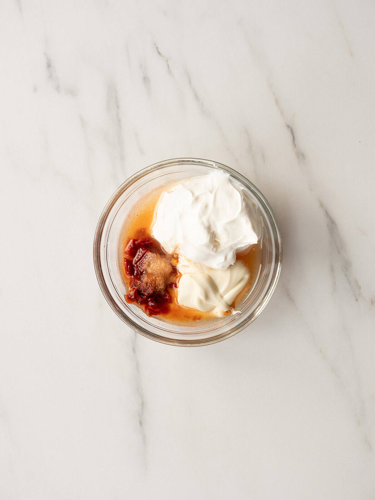 Chipotle sour cream ingredients in a glass bowl