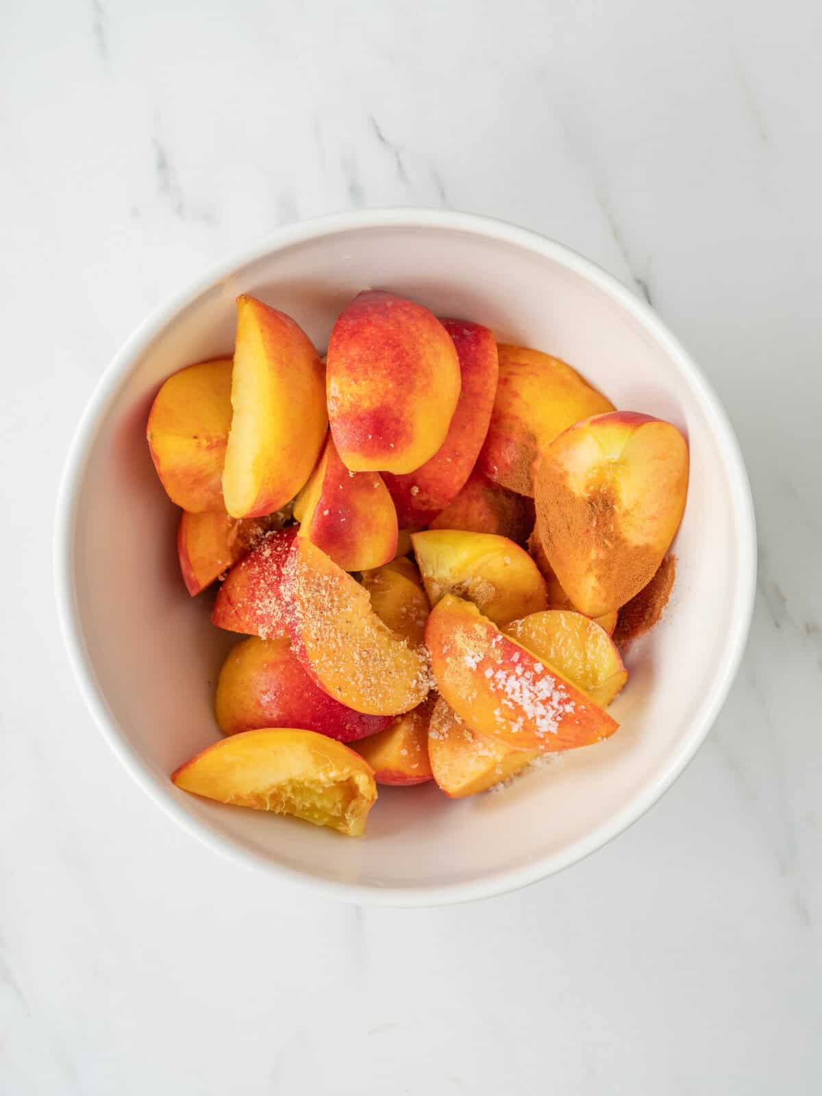 Sliced peaches with sugar and spices