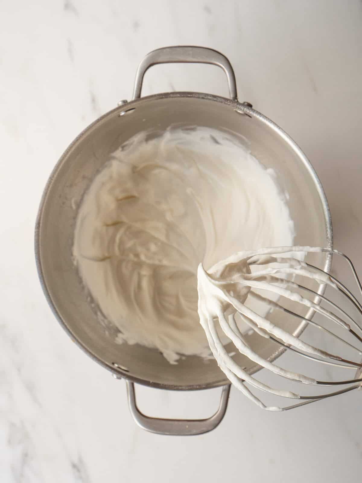 Whipped cream in metal mixing bowl