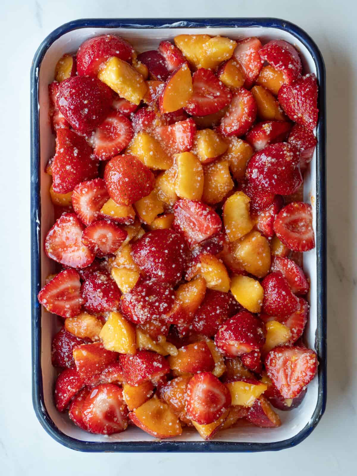 Fresh strawberries and peaches, sugared.
