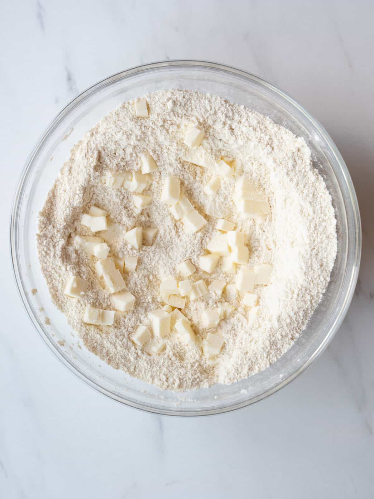 Bowl of flour with butter pieces