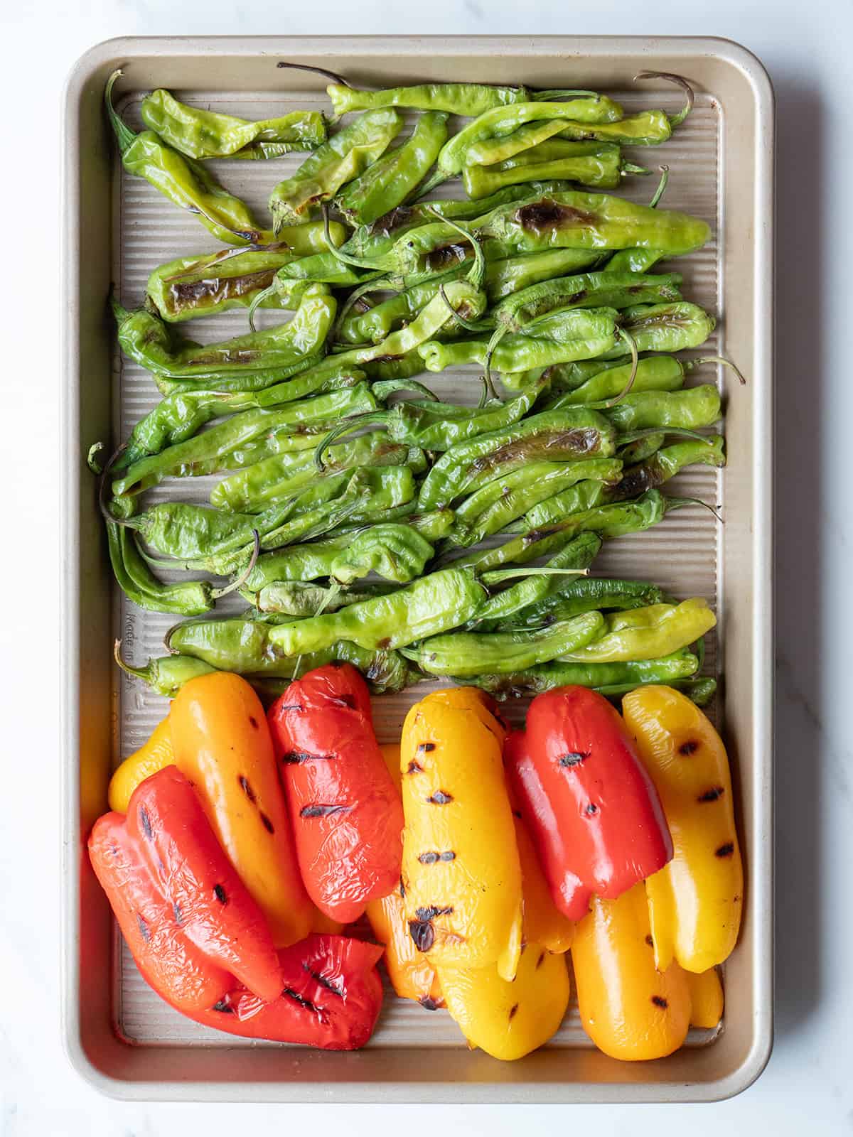 Grilled peppers on a baking tray