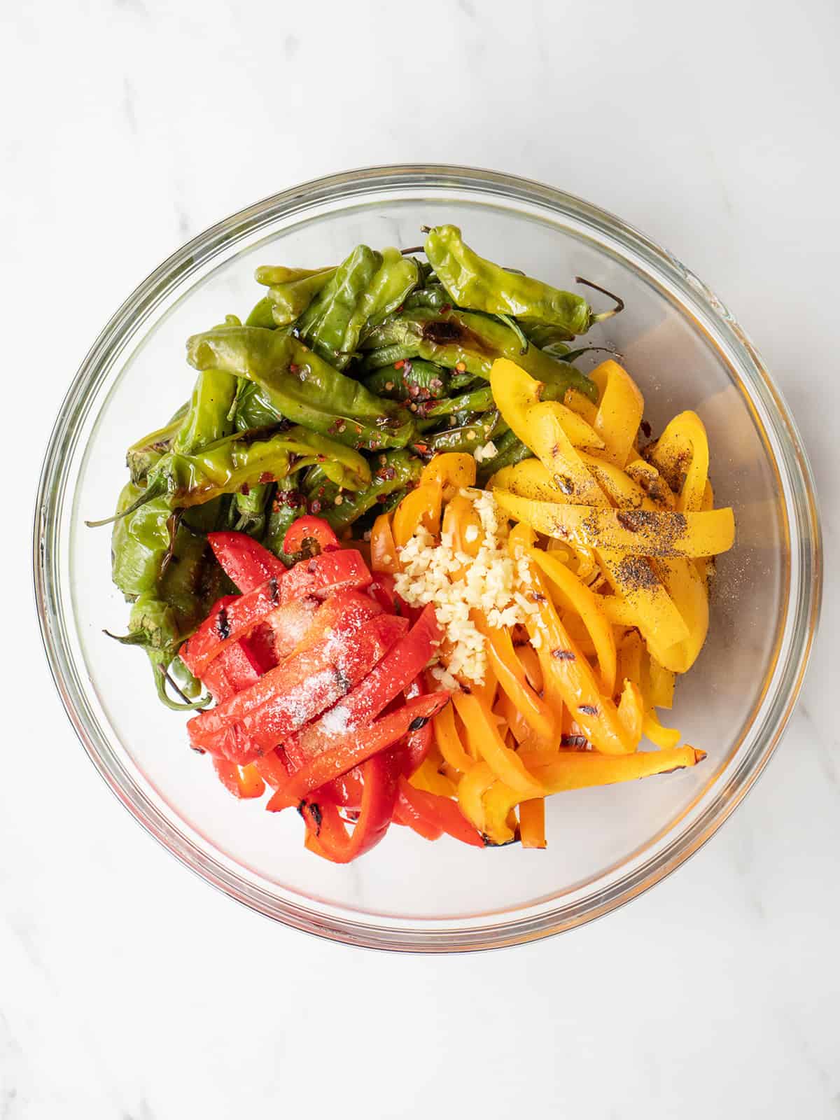 Colorful grilled peppers in a glass bowl