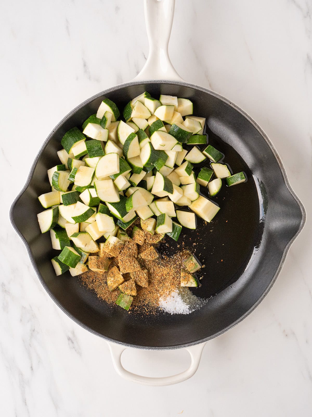 Zucchini, olive oil, salt, and Dalkin & Co Tuscan seasoning in a large skillet