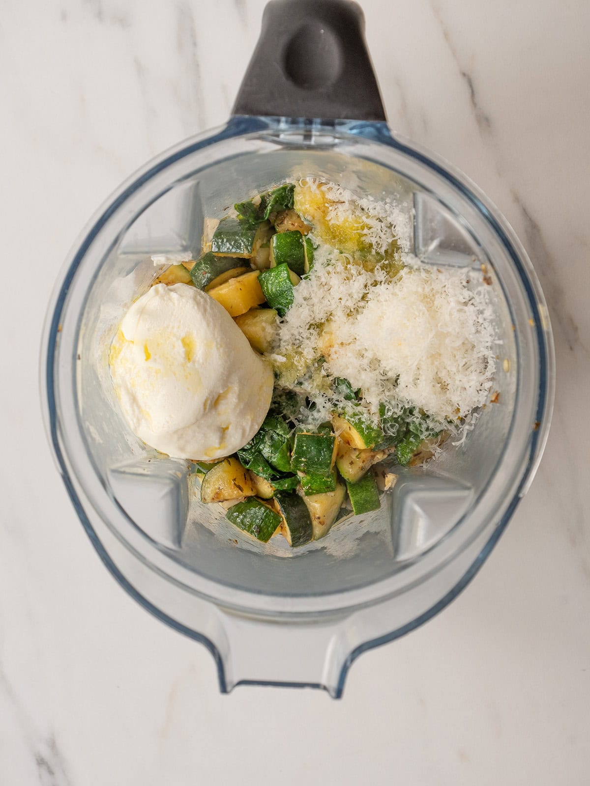 Cooked zucchini mixture, parmesan, ricotta, olive oil, and lemon juice in a blender