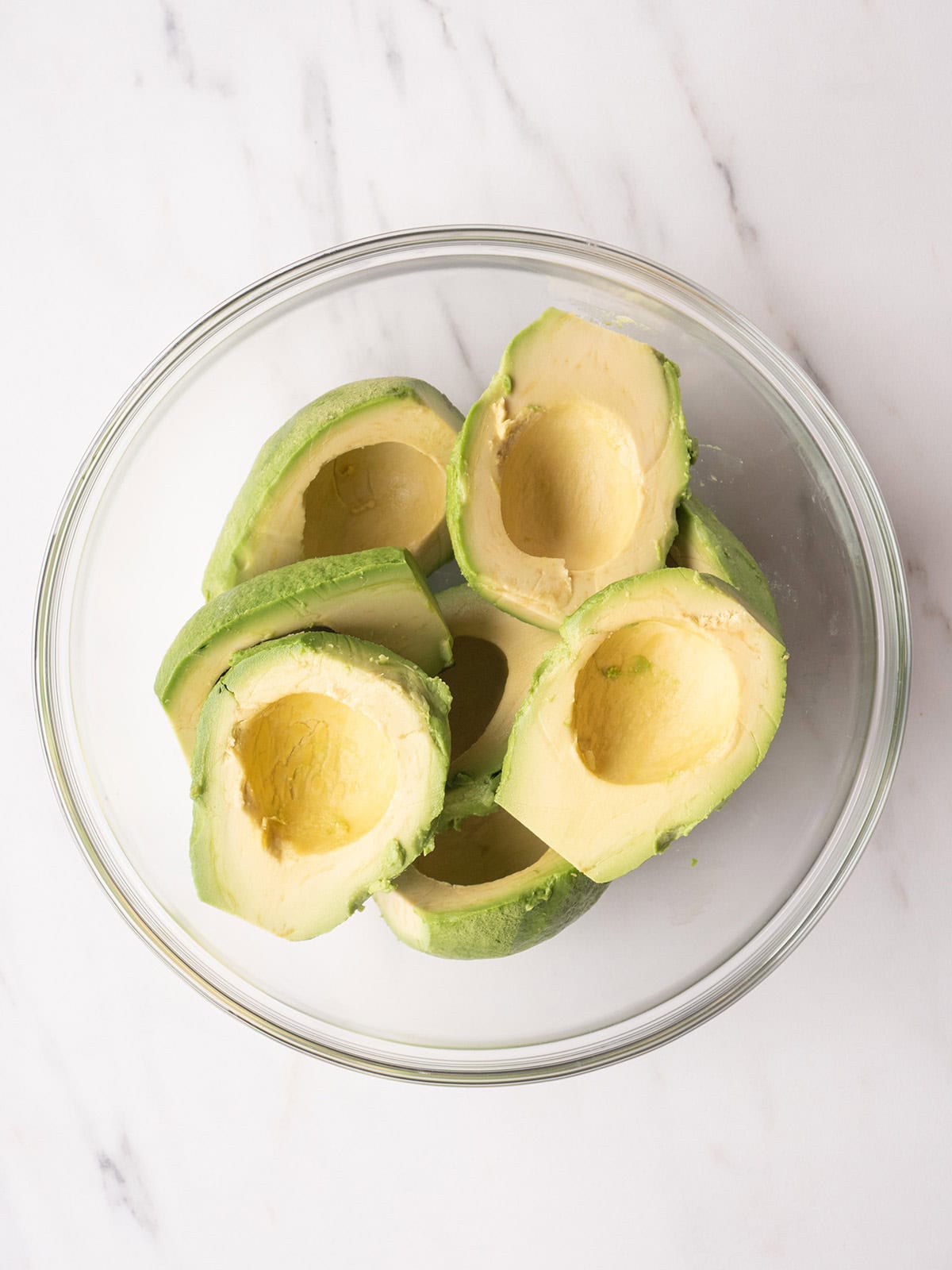 Avocado halves in a bowl