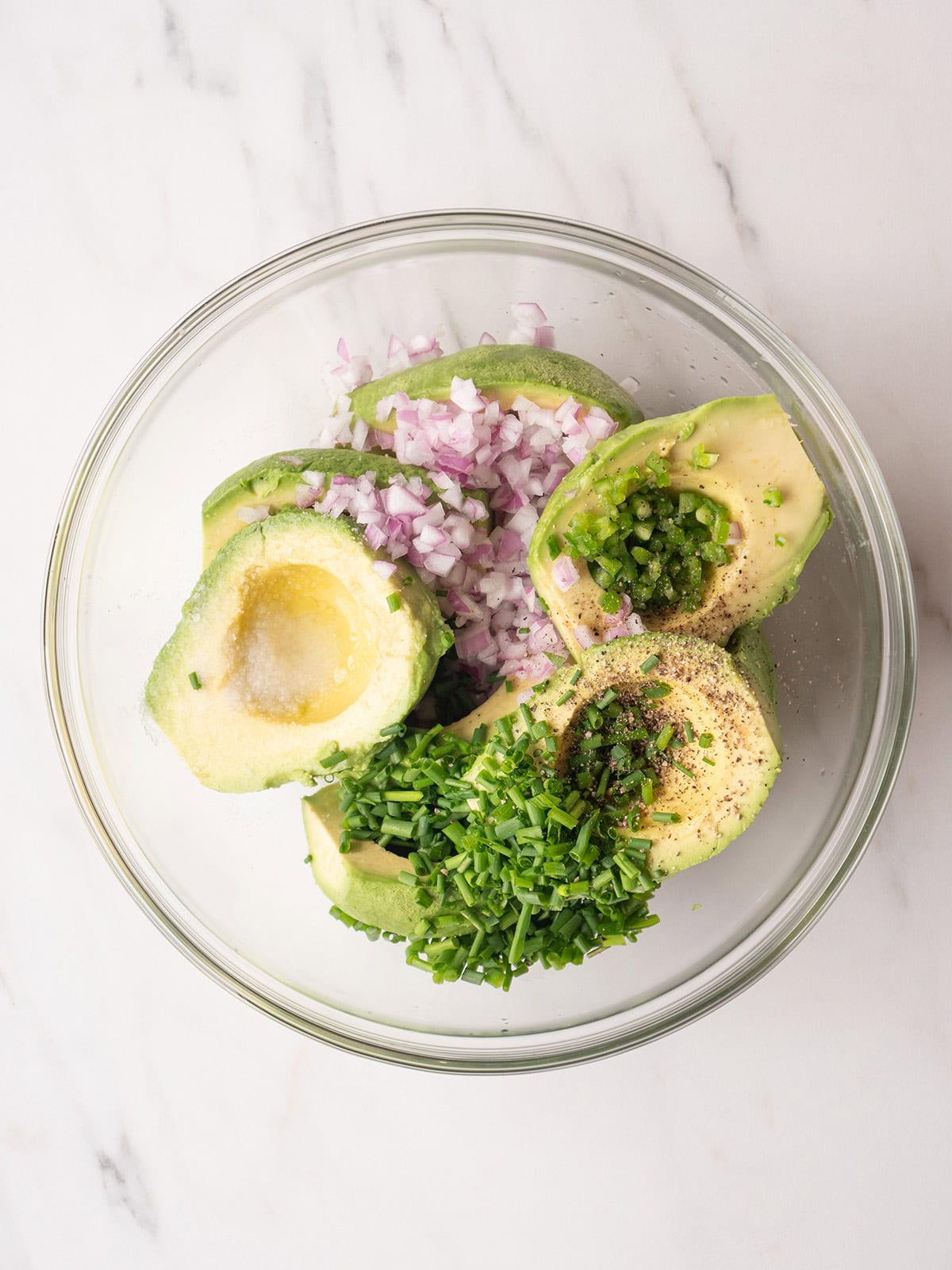 Ingredients for guacamole layered in a bowl