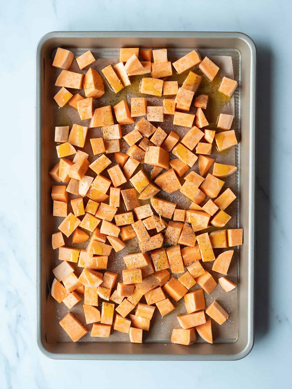 Diced sweet potatoes on a baking sheet for California Cobb Salad