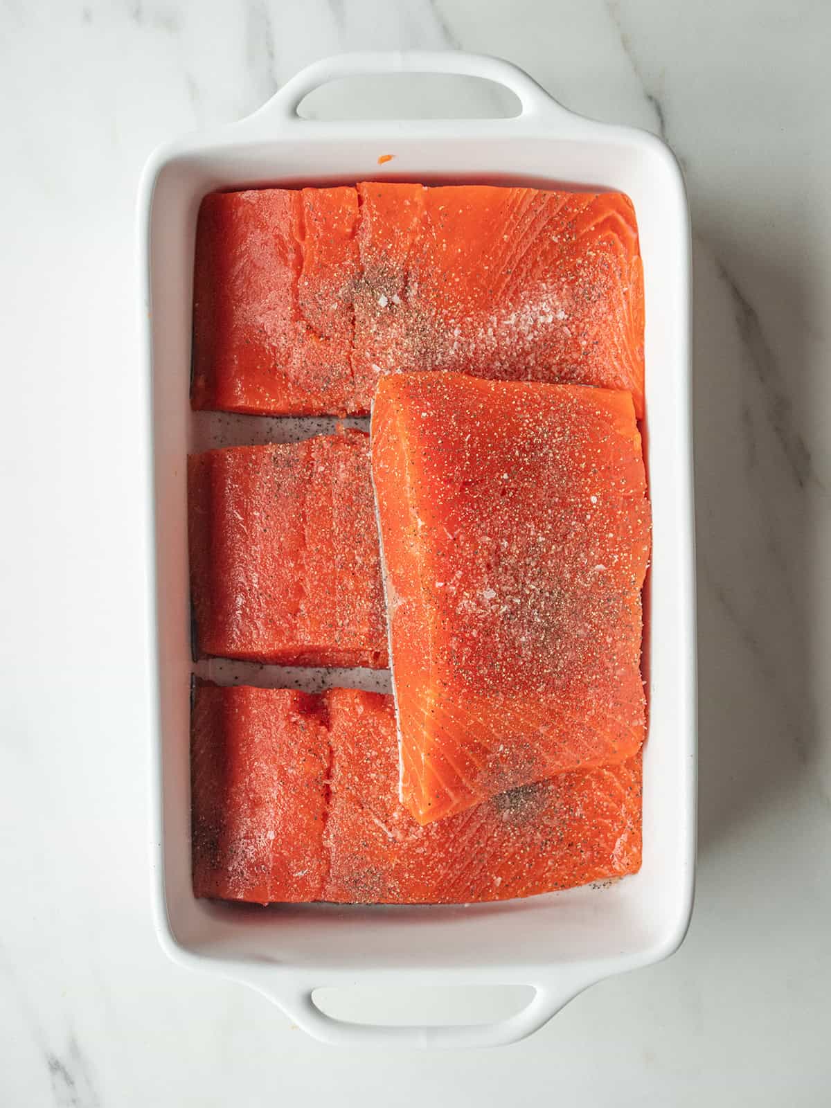 Salmon pieces seasoned with salt and pepper