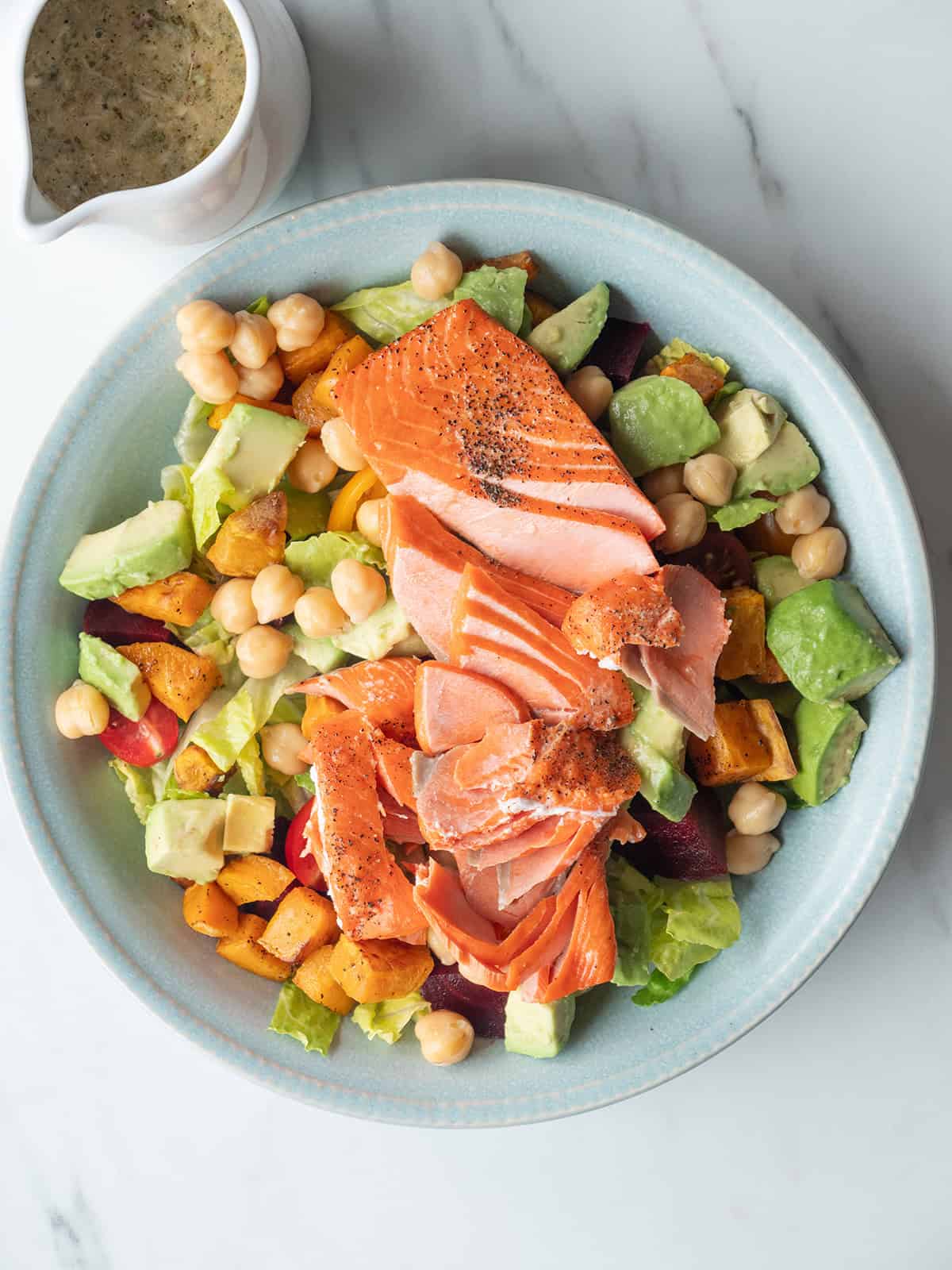 California Cobb Salad in a bowl with Mustard Herb Vinaigrette on the side