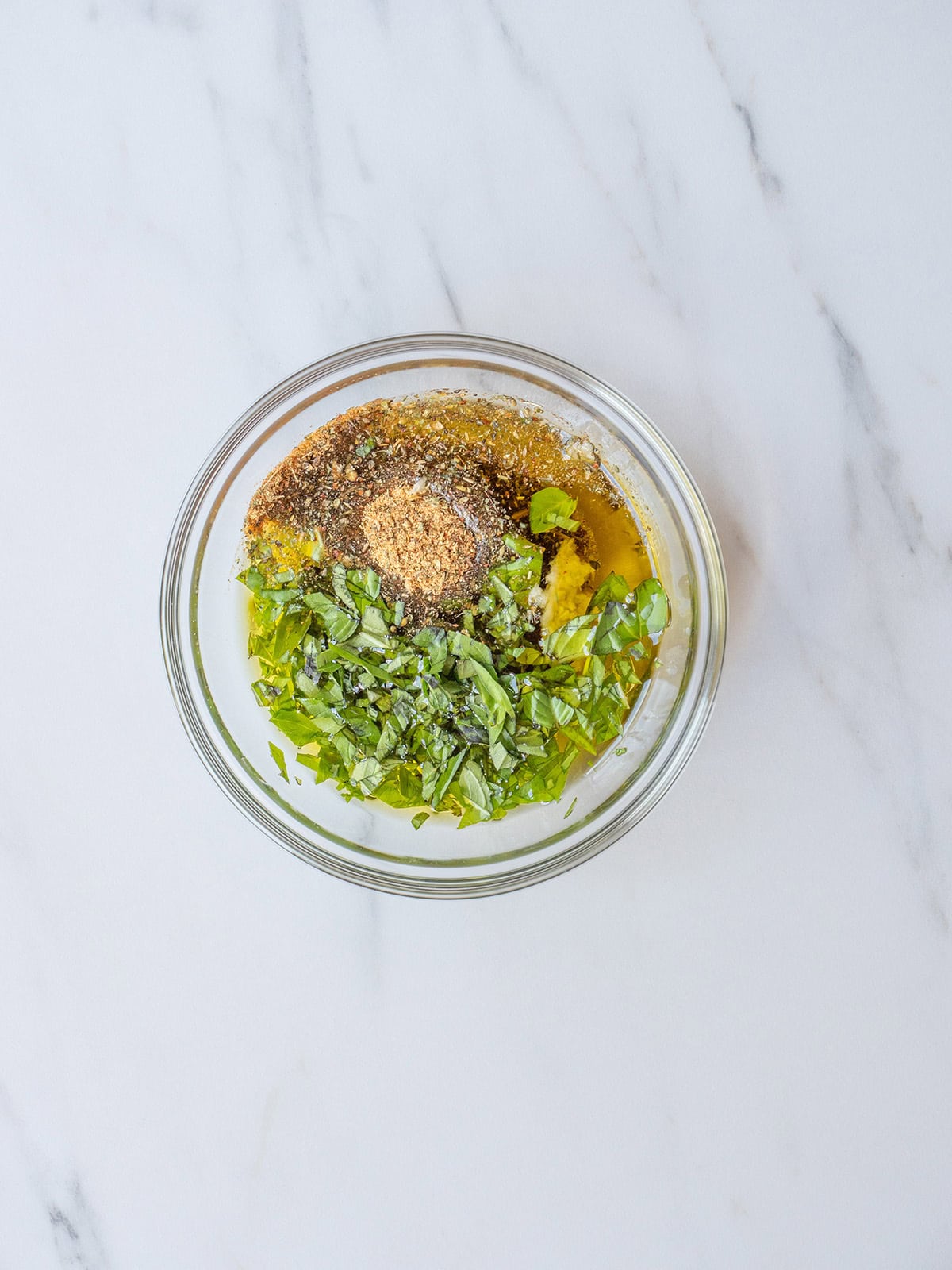 Olive Oil, Garlic, Dalkin&Co Tuscan Seasoning, and basil in a small bowl