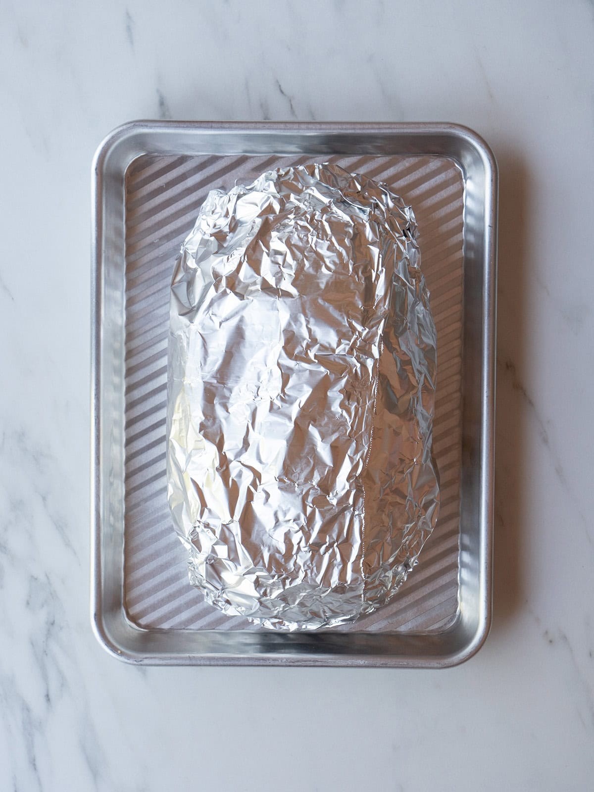 Bread wrapped in foil for the Cheesy Pull-Apart Bread