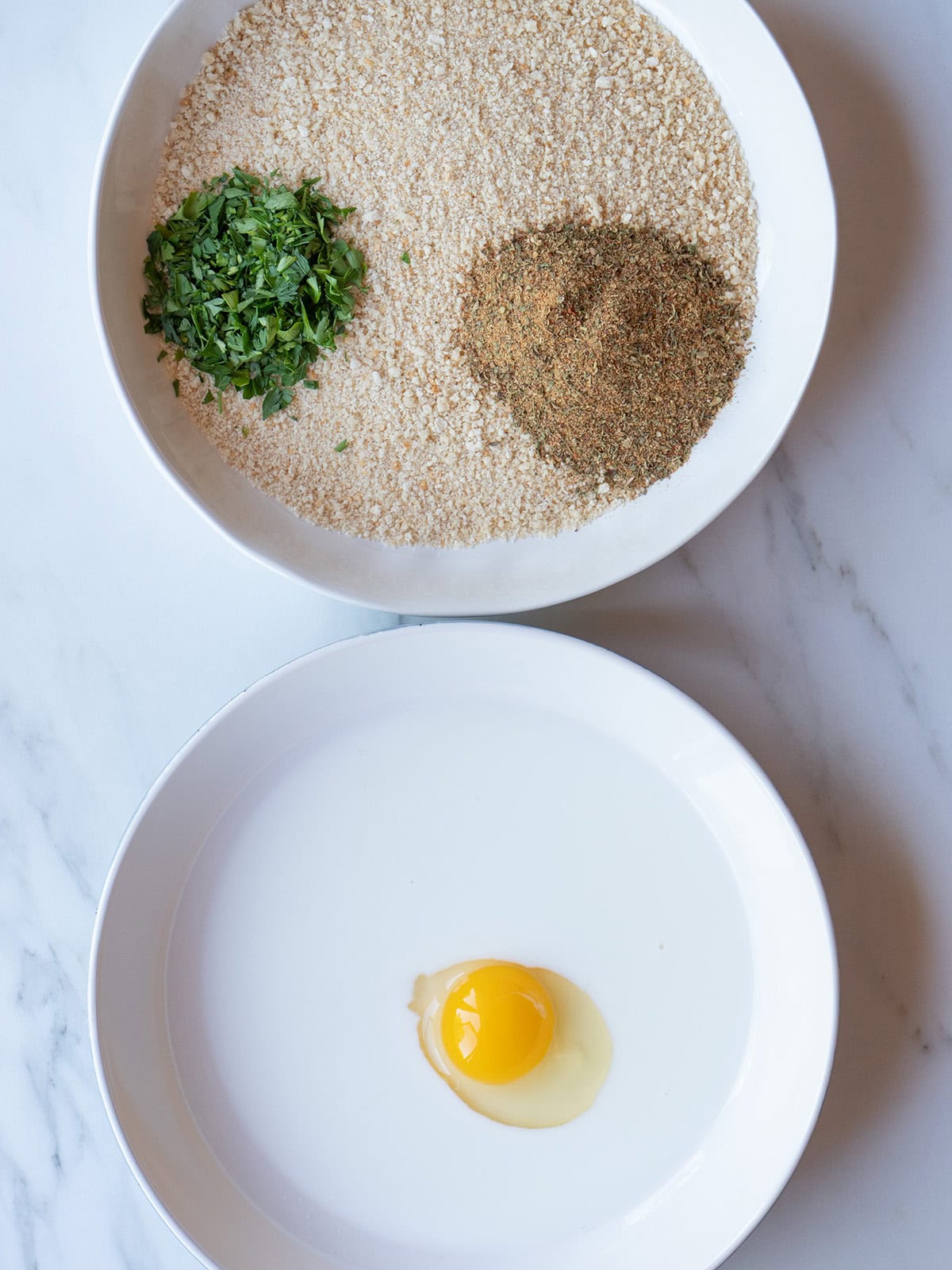 A dish with milk and egg and a dish with panko, parsley and Dalkin&Co Tuscan blend for Fried Ravioli