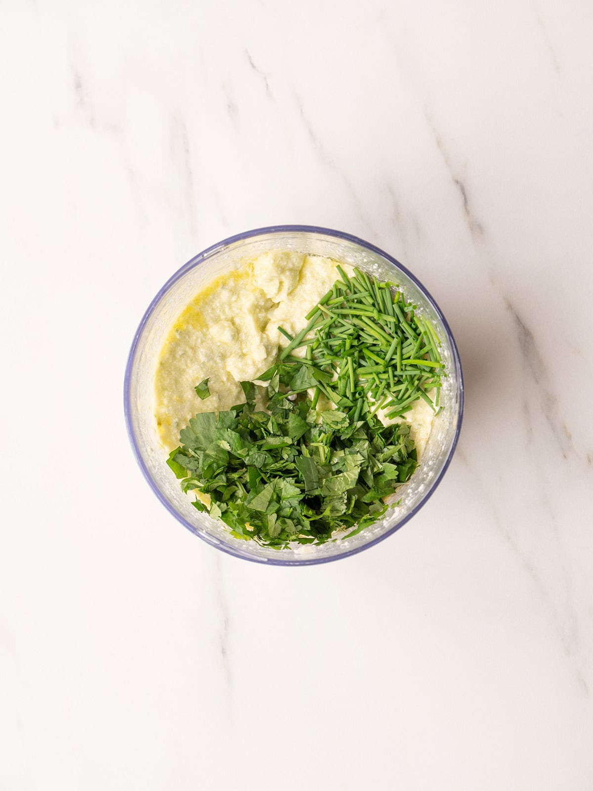 Bowl of creamy herb mixture.