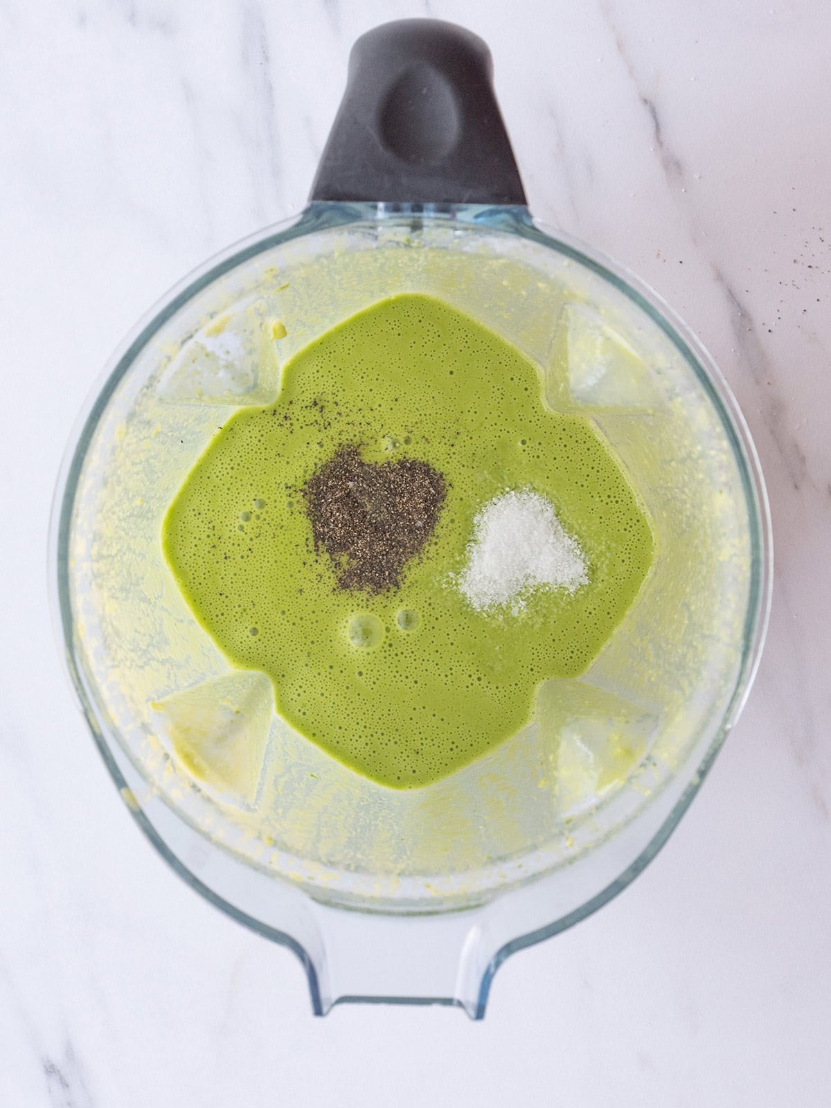 Salt and pepper added to a marinade in a blender