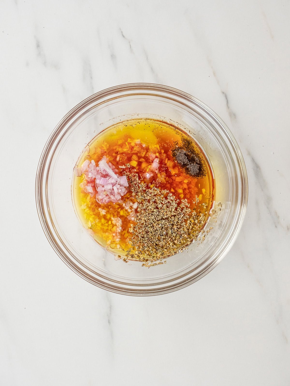 Mixing dressing ingredients in a glass bowl