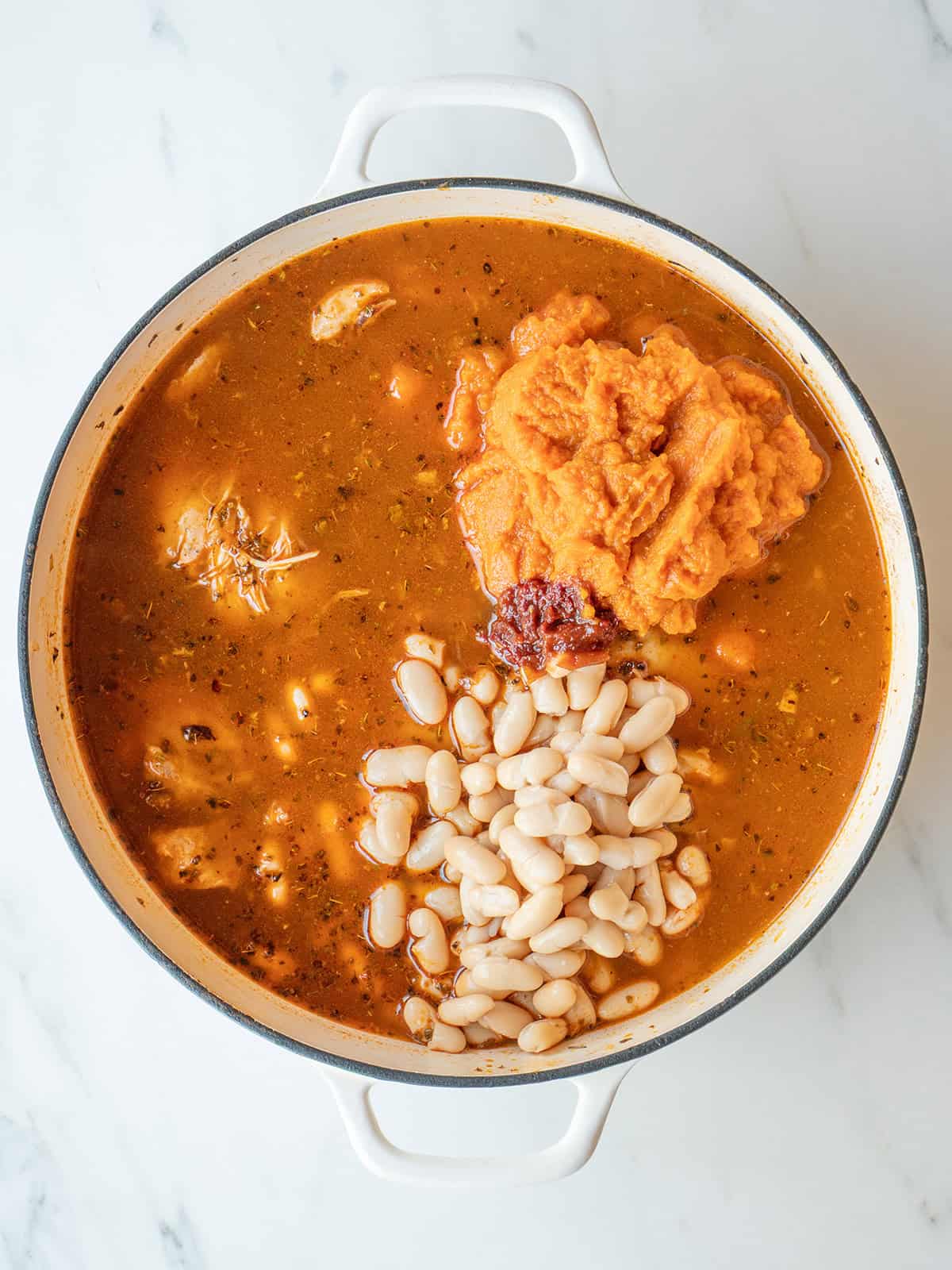 Pumpkin Chicken Chili simmering with white beans and chicken