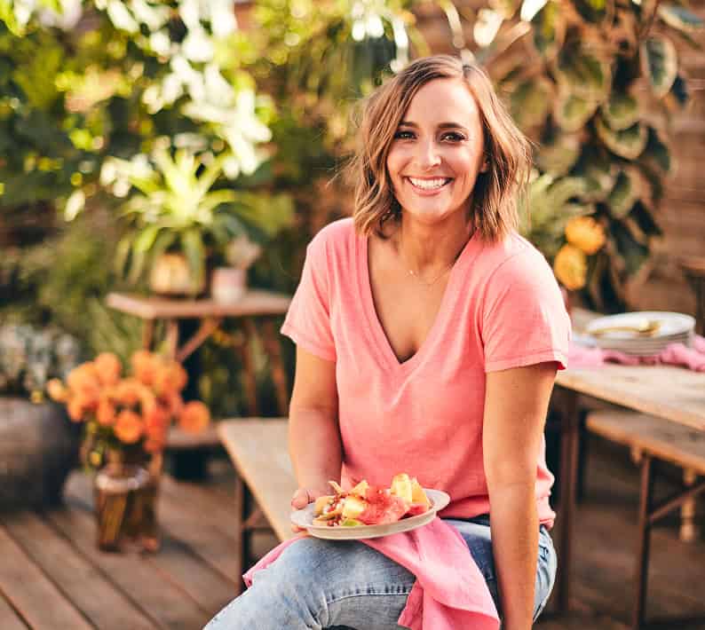 Gaby in a pink shirt smiling