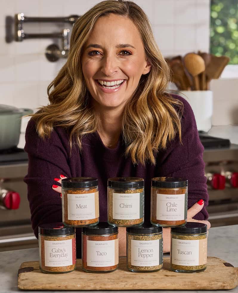 Gaby smiling with her line of seasoning