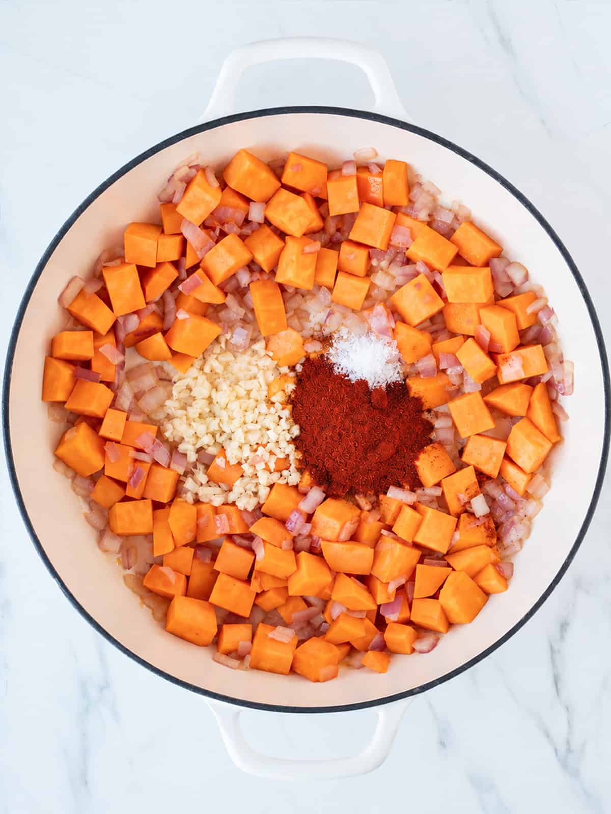 Chopped sweet potatoes, onions and spices arranged