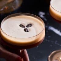 Two espresso martinis with coffee beans