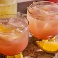Two cocktails with ice and orange