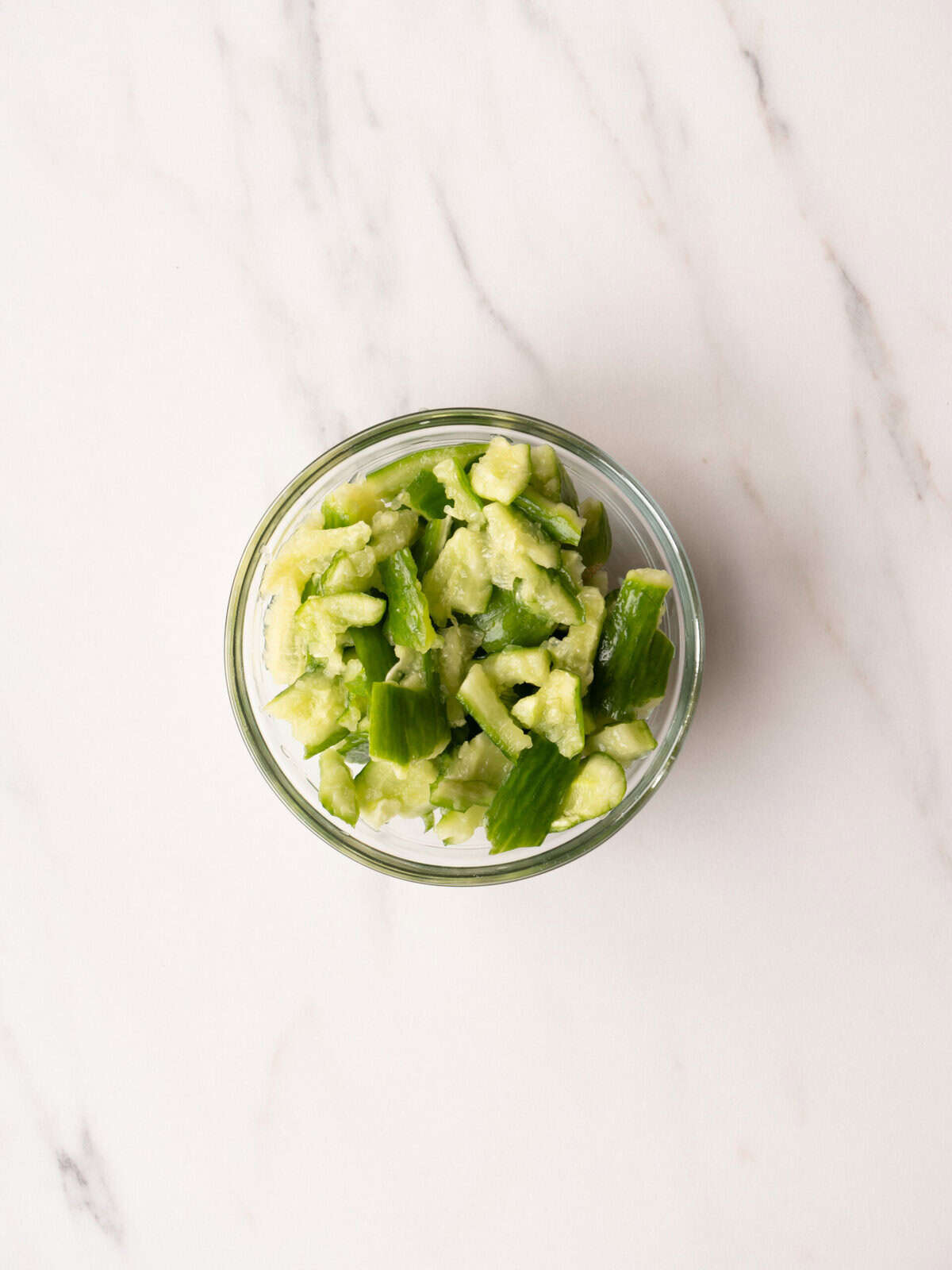 Chopped green vegetables in glass bowl