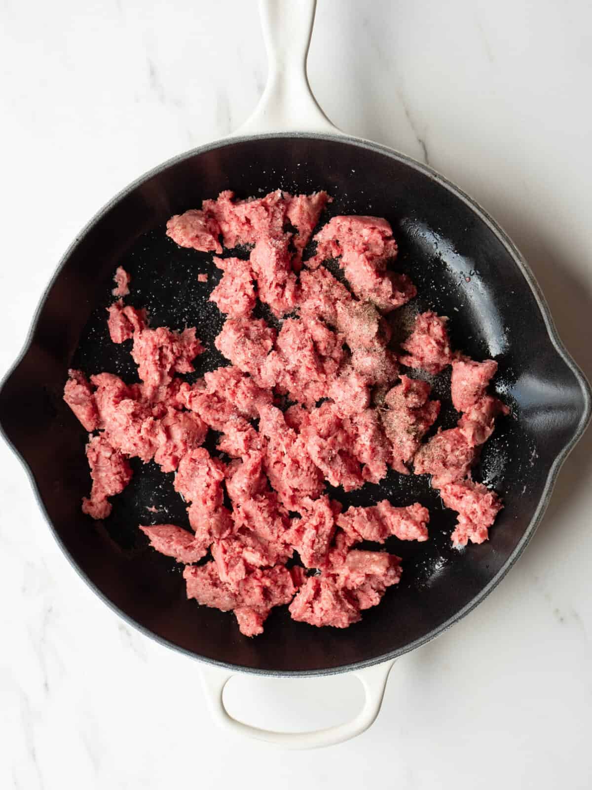 Raw ground beef in skillet