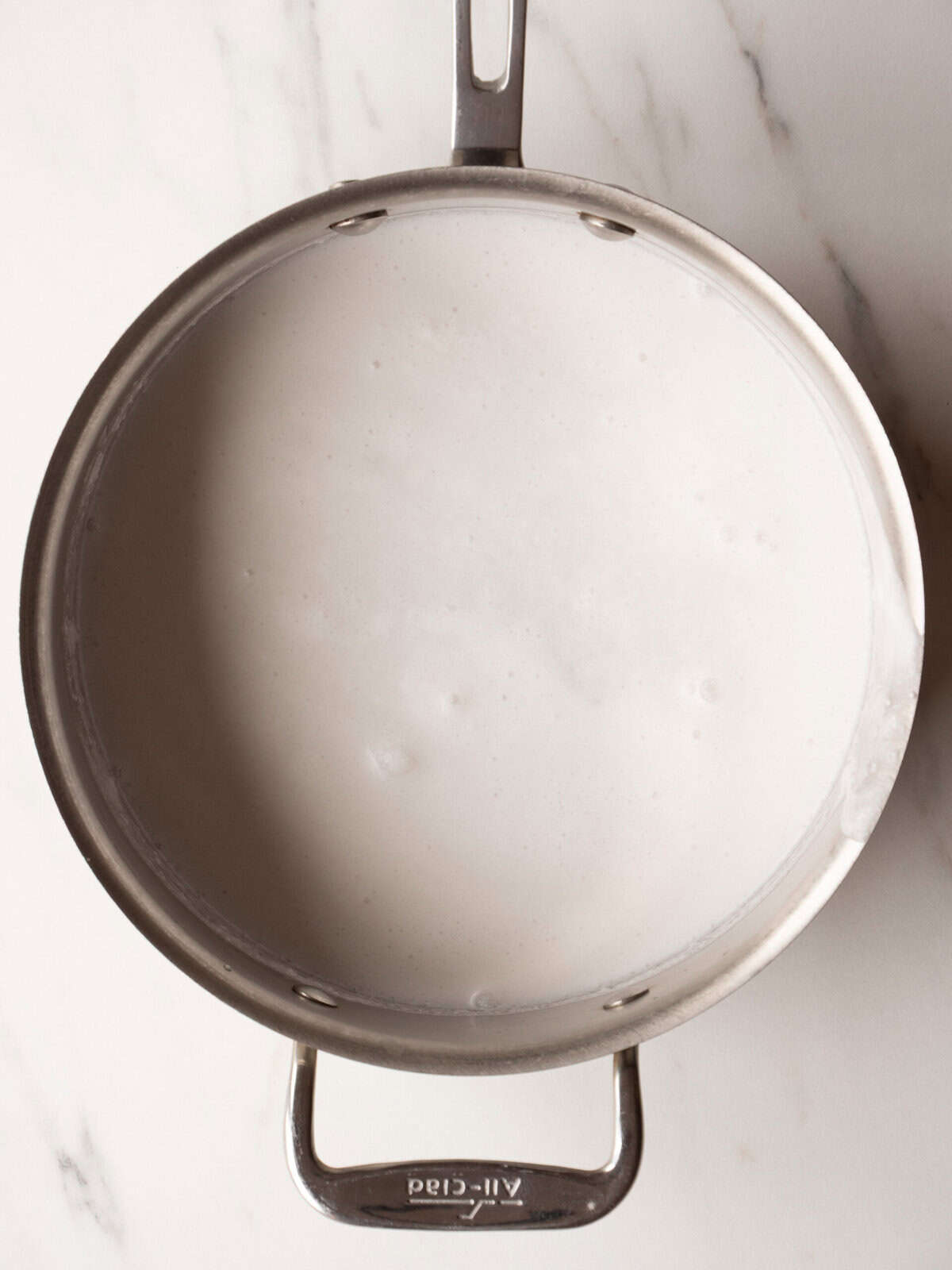 Metal pan with creamy liquid inside